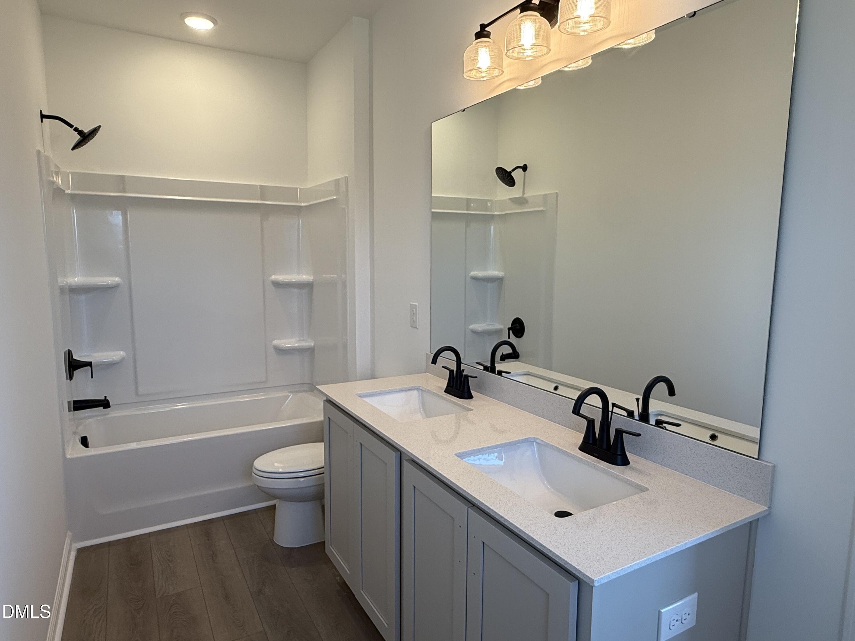 433 Contempo Court, Unit 3 Rolesville, NC 27571 - Photo 23 of 40 a bathroom with a sink a toilet and shower
