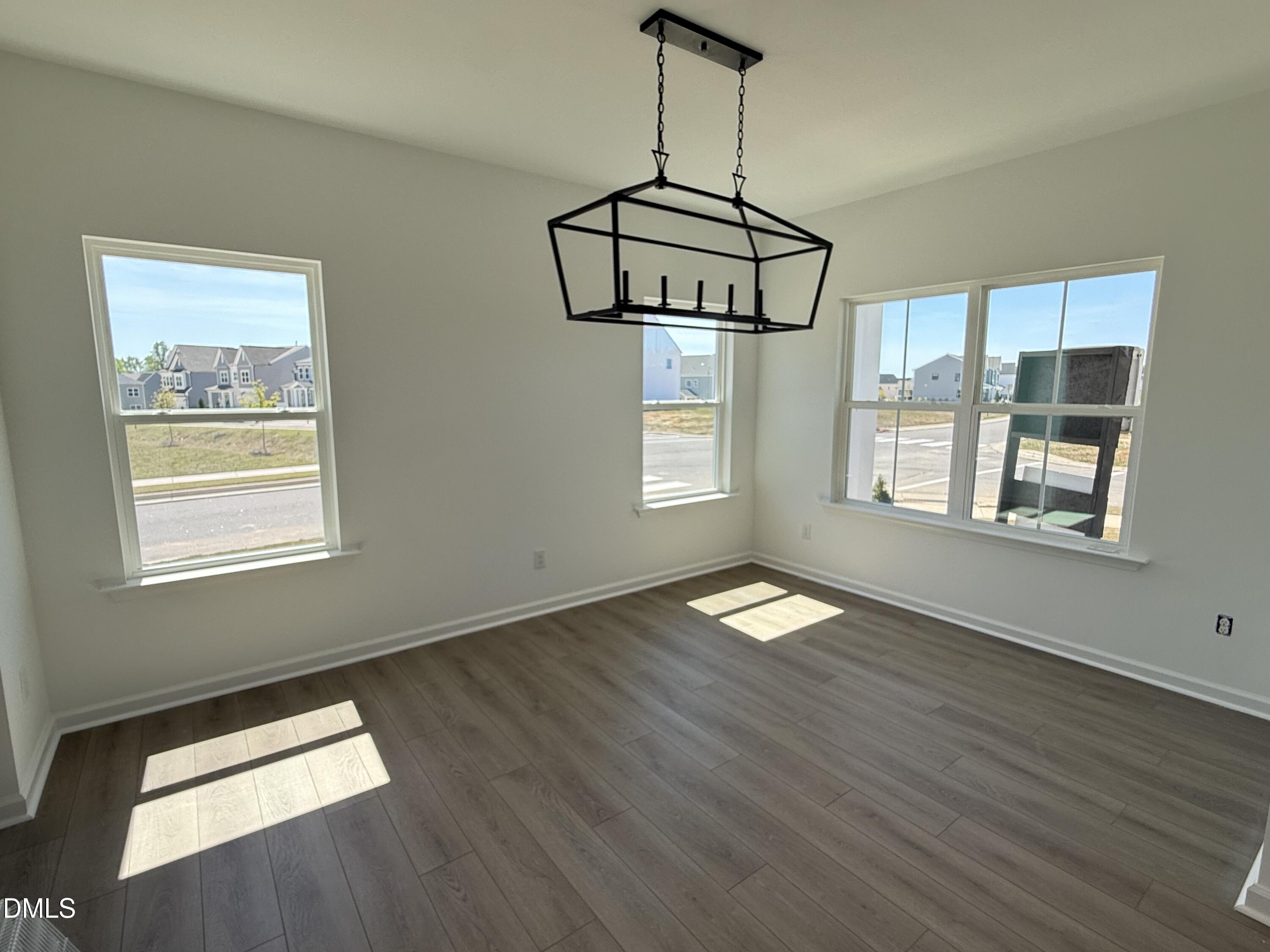 433 Contempo Court, Unit 3 Rolesville, NC 27571 - Photo 3 of 40 a view of empty room with wooden floor and windows
