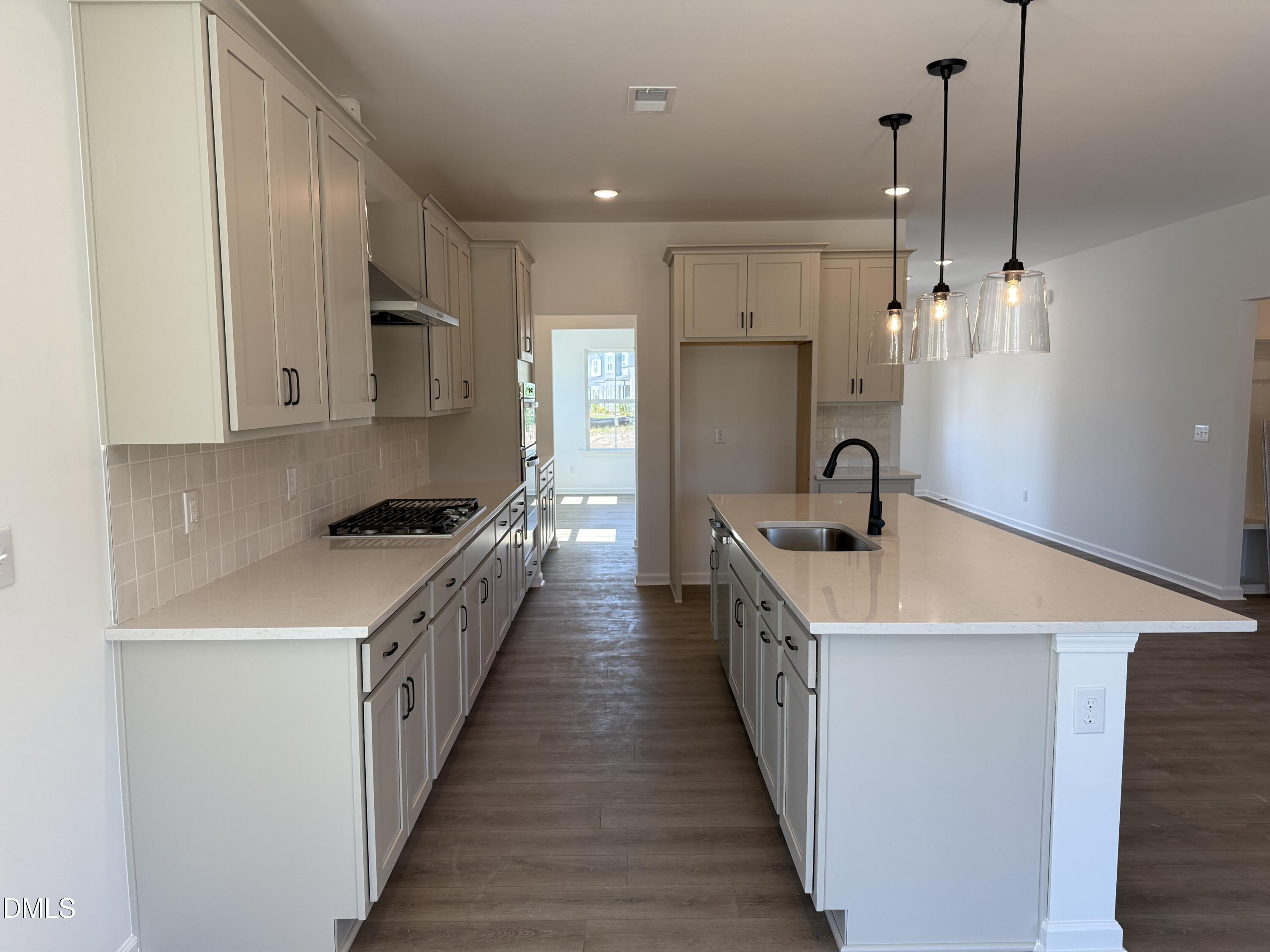 433 Contempo Court, Unit 3 Rolesville, NC 27571 - Photo 6 of 40 a kitchen with sink a stove and refrigerator