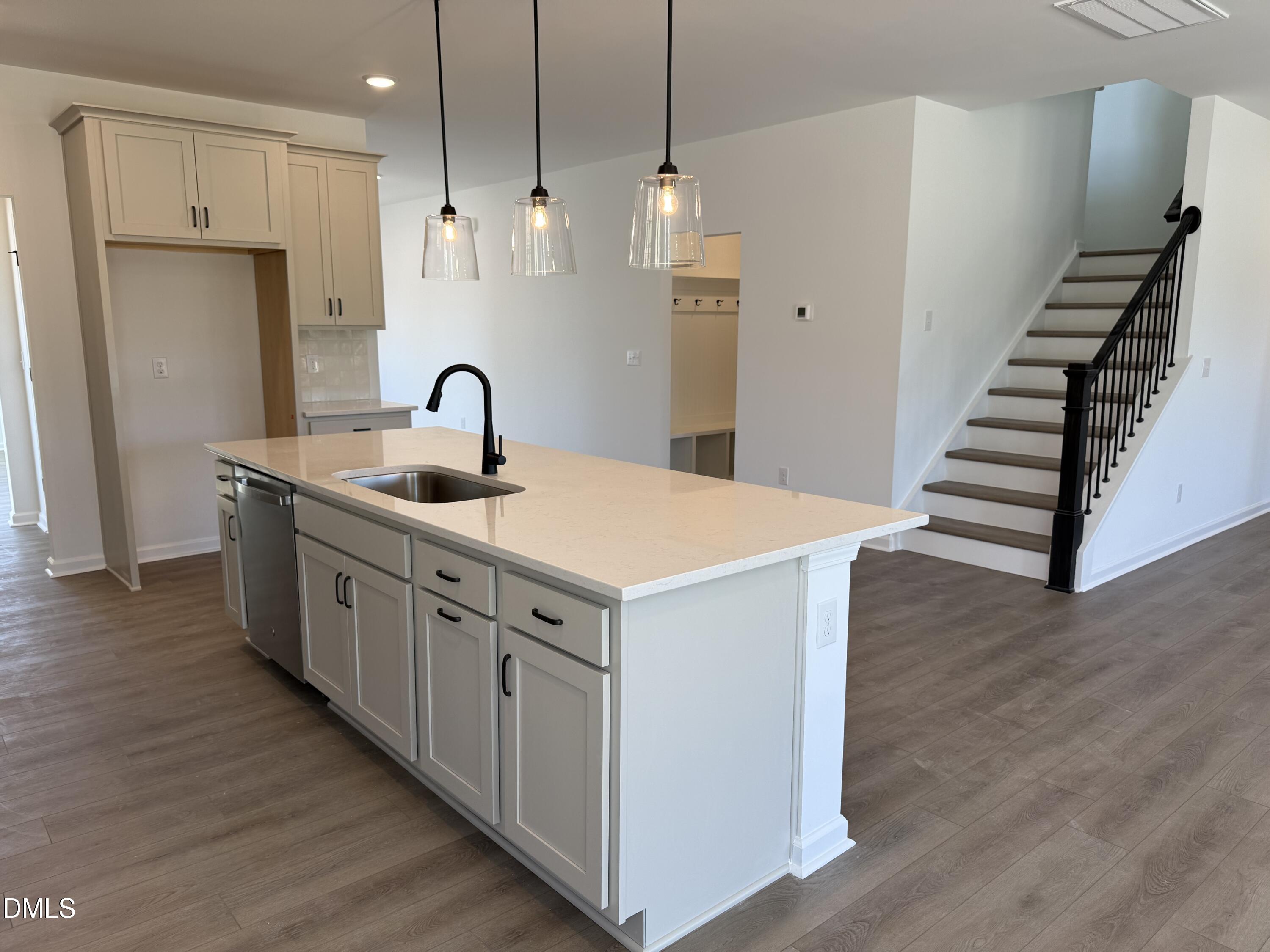 433 Contempo Court, Unit 3 Rolesville, NC 27571 - Photo 7 of 40 a kitchen with white cabinets and sink
