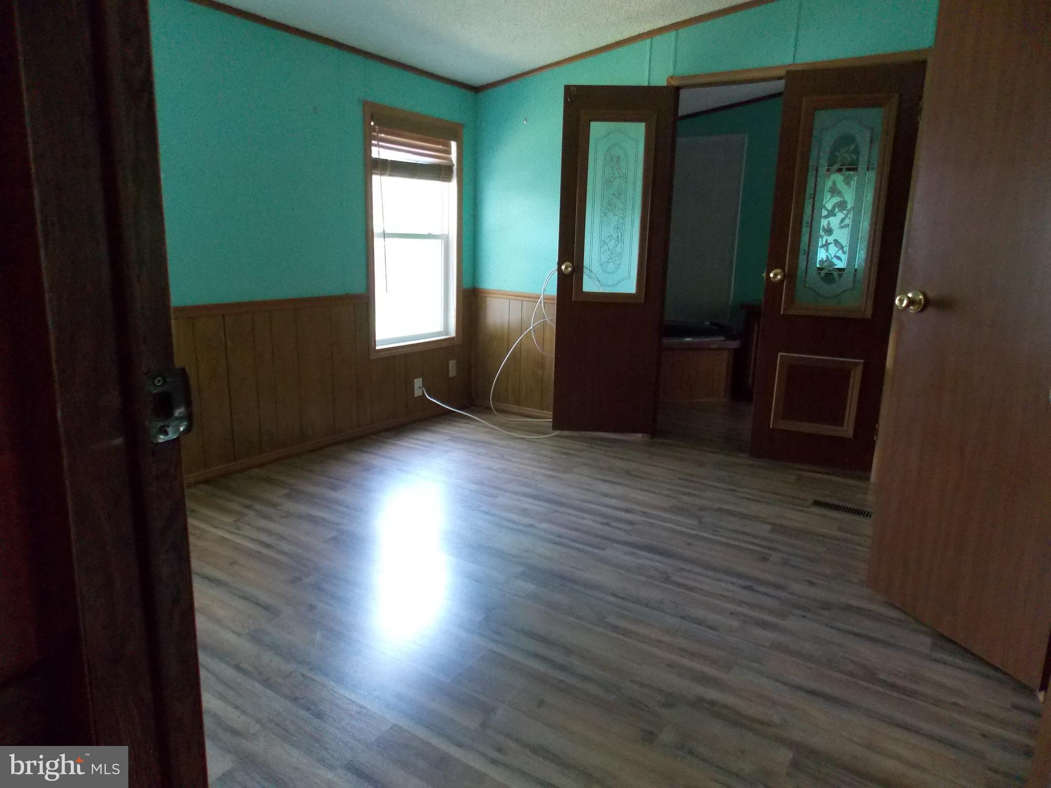 76 Big Spring Terrace Newville, PA 17241 - Photo 7 of 16 an empty room with wooden floor and windows
