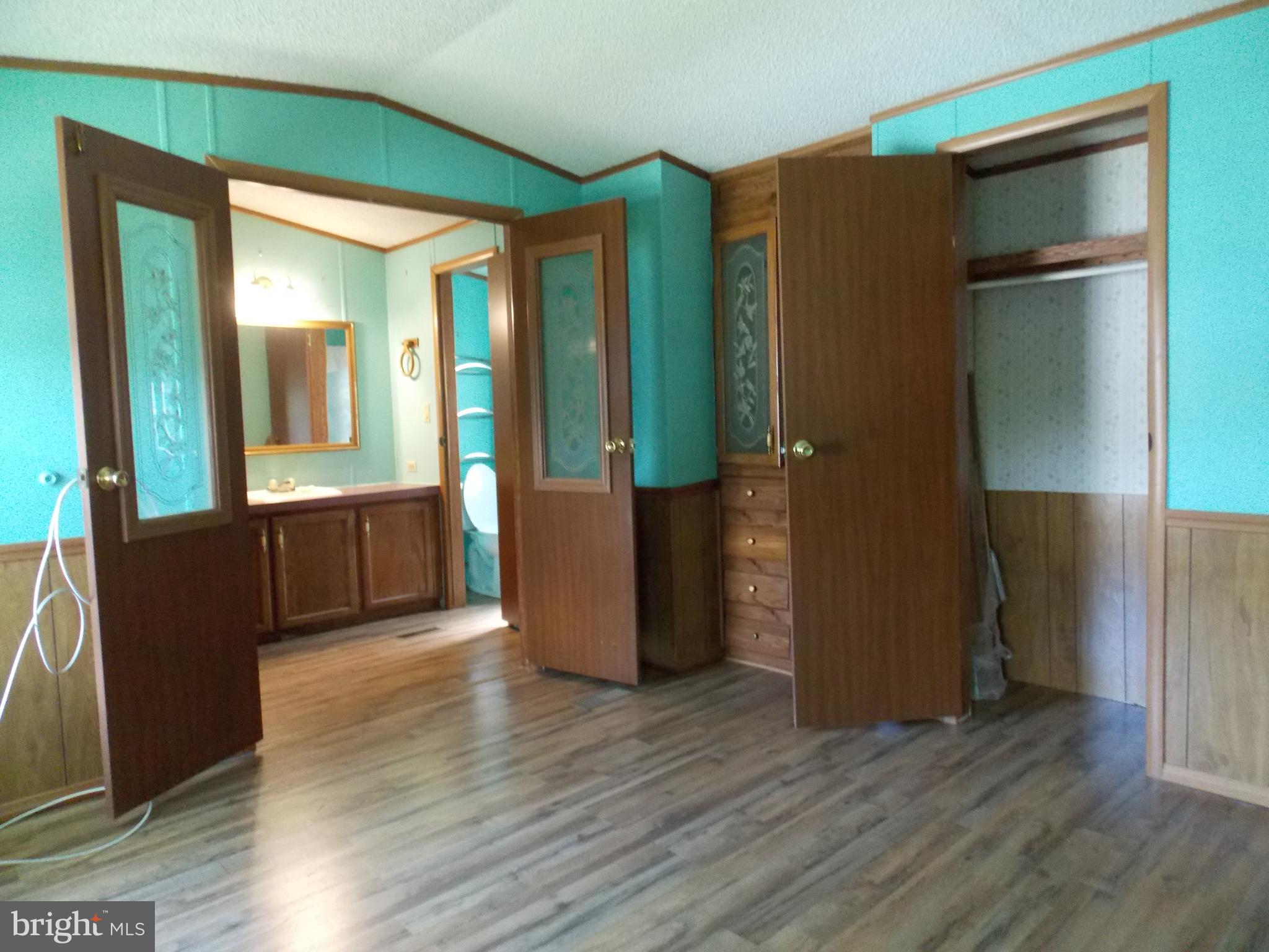 76 Big Spring Terrace Newville, PA 17241 - Photo 9 of 16 an empty room with wooden floor and windows