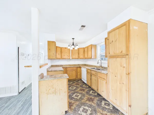a kitchen with a refrigerator a stove top oven with wooden floor