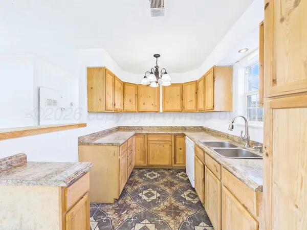 a kitchen with granite countertop a sink stove and cabinets