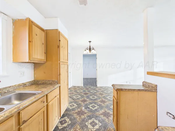 a bathroom with a granite countertop sink a mirror and a shower