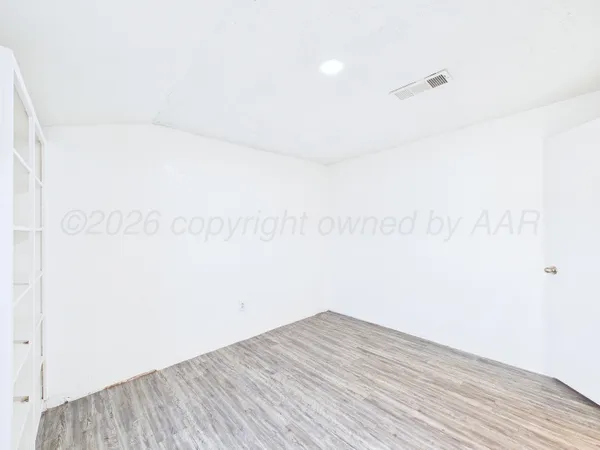 a view of a room with wooden floor