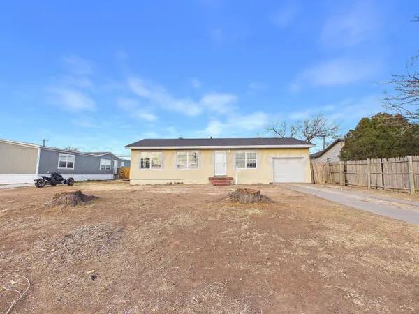 a big house with a big yard and large trees