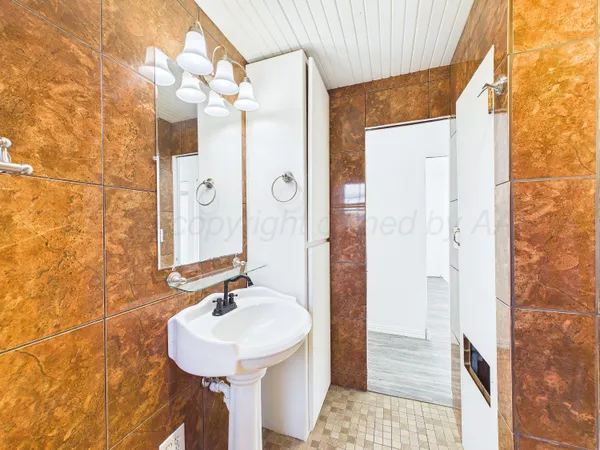 a bathroom with a sink a mirror and shower