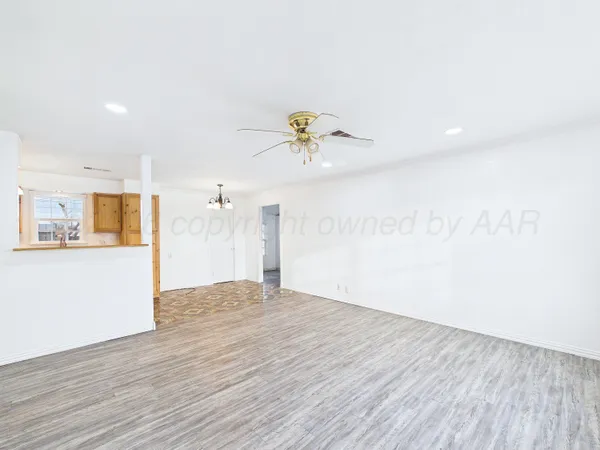 a view of a room with wooden floor