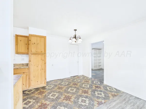a view of a bedroom with wooden floor