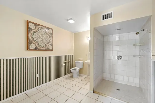 a bathroom with a sink double vanity mirror and bathtub