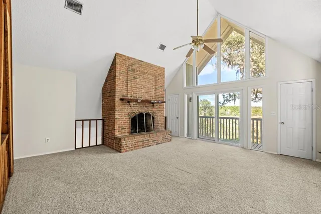 a front view of a house with a yard and outdoor seating