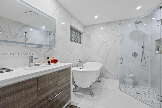 a bathroom with a sink mirror toilet and shower