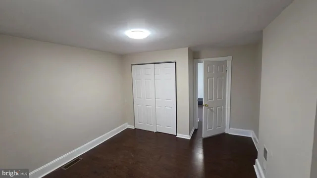 an empty room with wooden floor