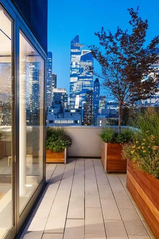 a view of a patio with dining table and chairs