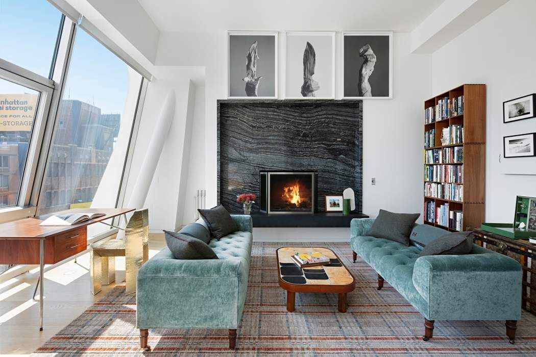 515 West 23rd Street, Unit PH Manhattan, NY 10011 - Photo 12 of 27 a living room with furniture and a fireplace
