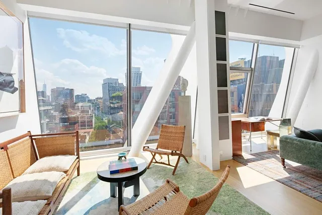 a living room with fireplace furniture and a large window