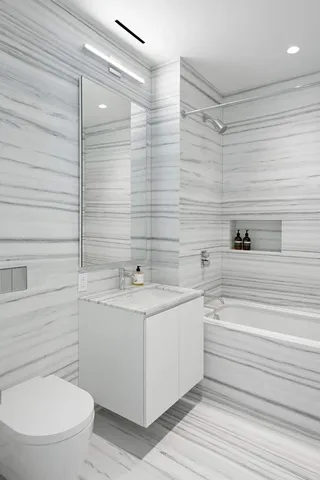 a bathroom with a toilet a sink and shower