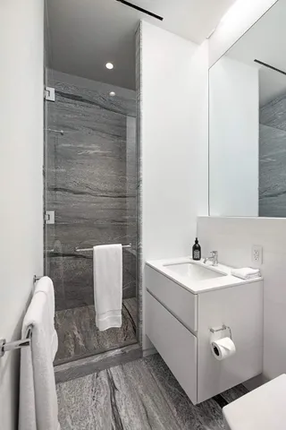 a bathroom with a sink a toilet and mirror