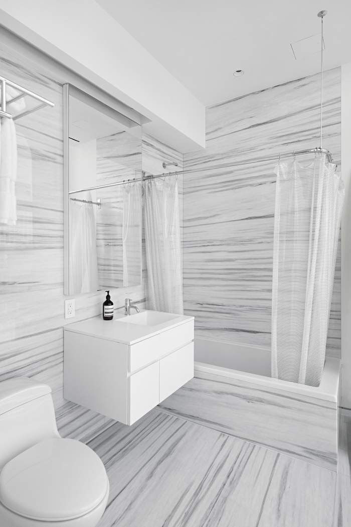 515 West 23rd Street, Unit PH Manhattan, NY 10011 - Photo 23 of 27 a bathroom with a sink a toilet a mirror and bathtub