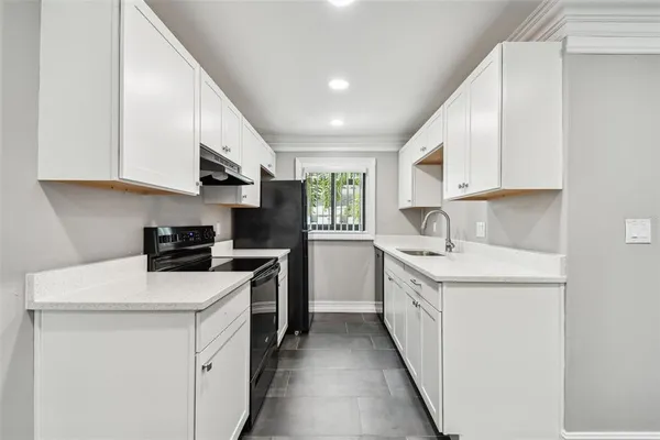 a kitchen with a sink cabinets and window