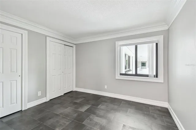 an empty room with windows and closet