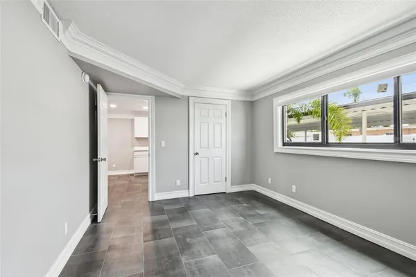 a view of a hallway with wooden floor and entryway