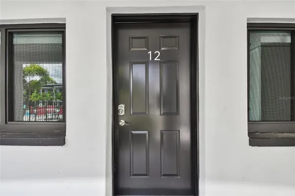 a view of a hallway with a door and a mirror