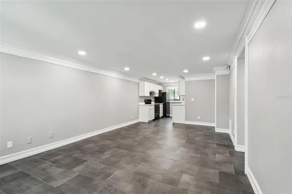 an empty room with windows and closet