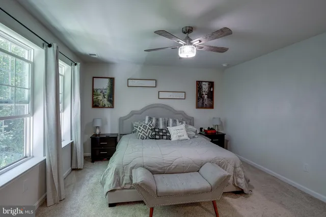 a bedroom with a bed and window