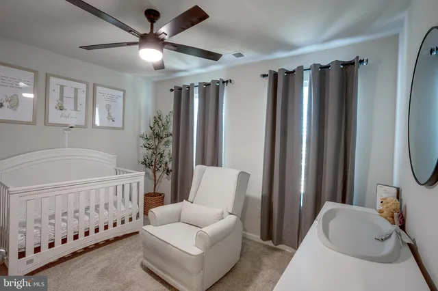 a bedroom with furniture and a large window