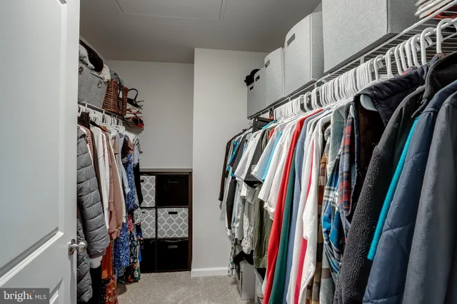 a view of walk in closet with clothes
