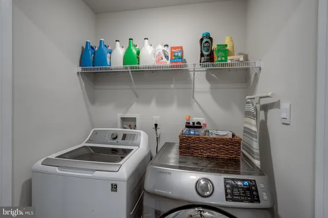 a kitchen with a stove and a wooden floor