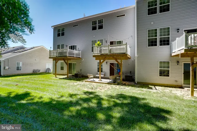 a balcony with wooden floor and outdoor seating