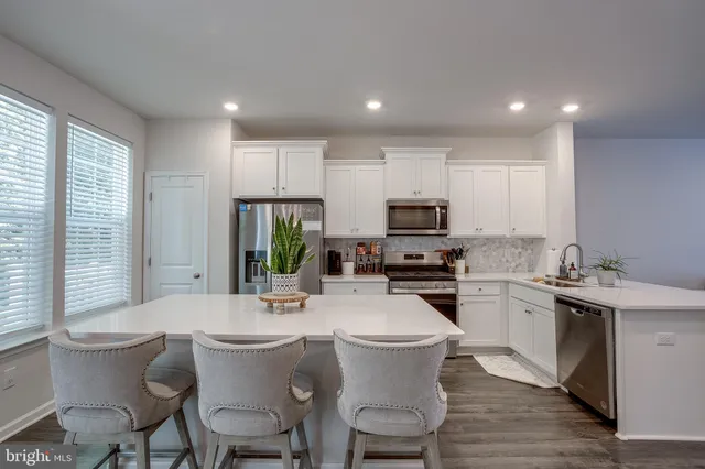 a kitchen with a sink stove and microwave