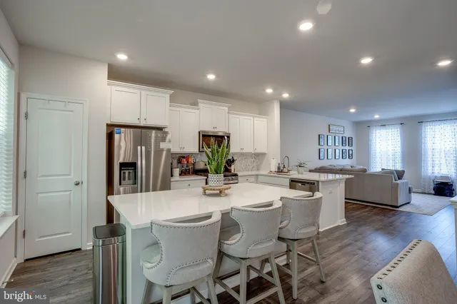 a view of a dining room with furniture a rug and wooden floor