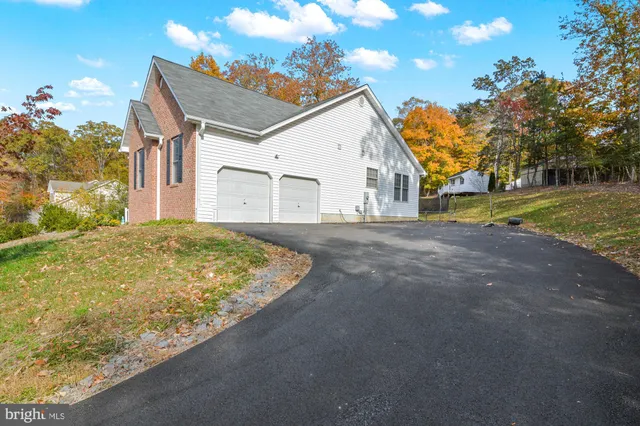 a view of backyard of house with green space