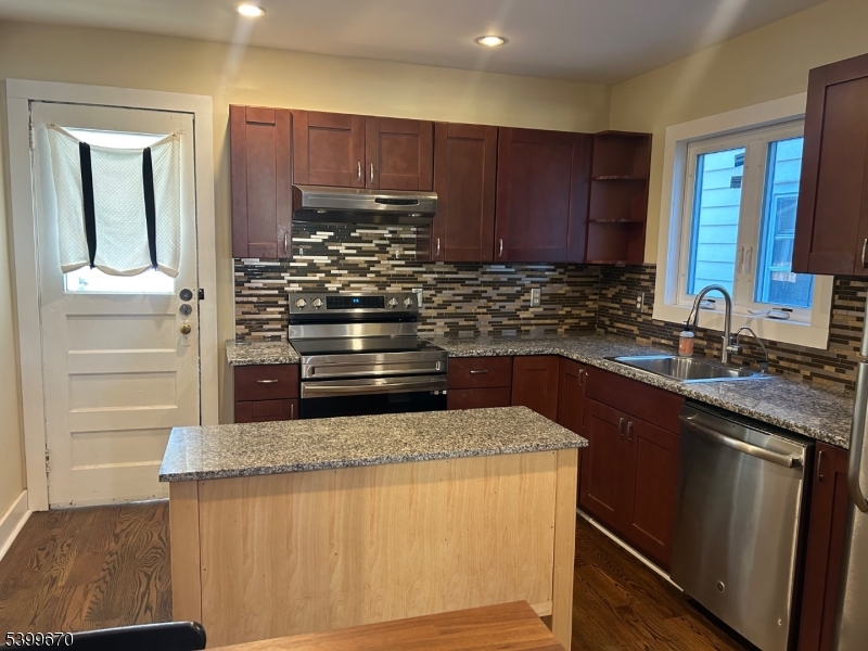 417 Valley Road Montclair, NJ 07043 - Photo 4 of 10 a kitchen with kitchen island granite countertop a sink stove and cabinets