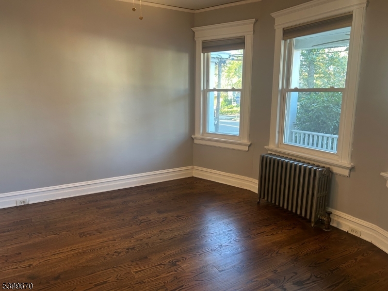 417 Valley Road Montclair, NJ 07043 - Photo 8 of 10 a view of an empty room with wooden floor and a window