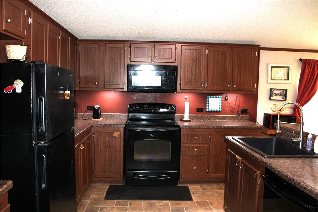 10780 County Road 3707 Wills Point, TX 75169 - Photo 17 of 34 a kitchen with a sink stove and refrigerator