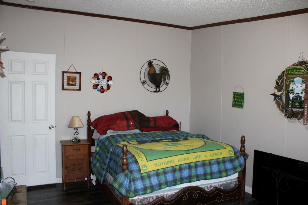 10780 County Road 3707 Wills Point, TX 75169 - Photo 28 of 34 a bedroom with a bed and painting on the wall
