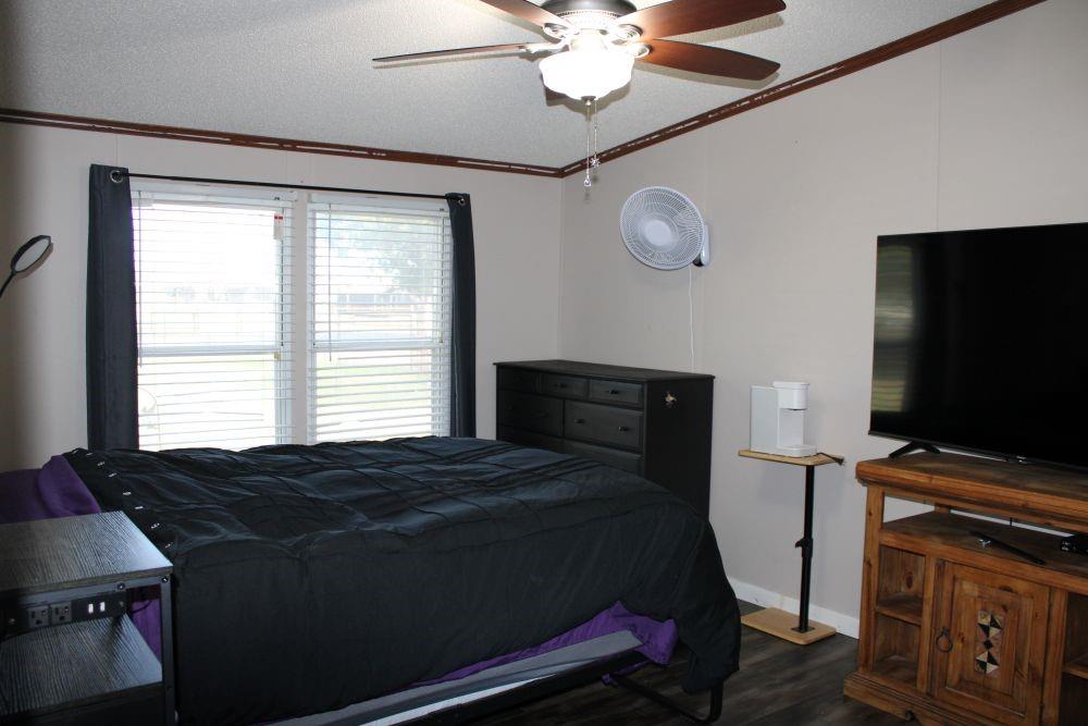 10780 County Road 3707 Wills Point, TX 75169 - Photo 30 of 34 a bedroom with a bed and a flat screen tv