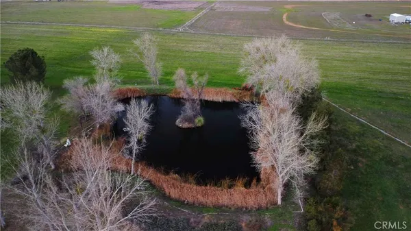 an aerial view of a golf course with a lake view