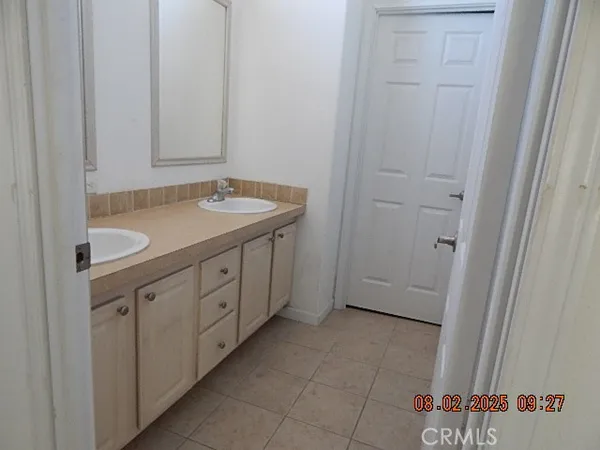 a kitchen with stainless steel appliances granite countertop a sink cabinets and wooden floor