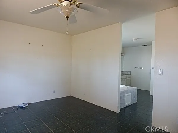 a view of a room with wooden floor and white walls