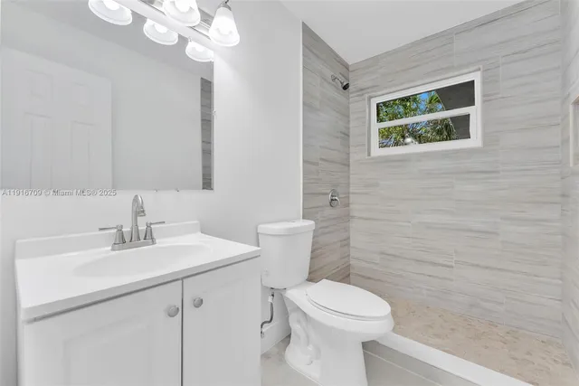 a bathroom with a sink a toilet and mirror