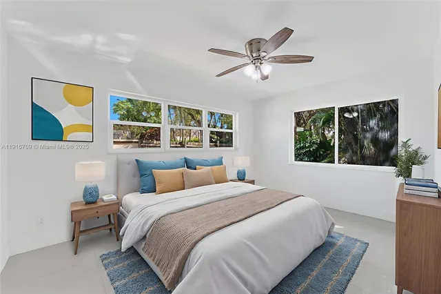 a bedroom with a large bed and a window