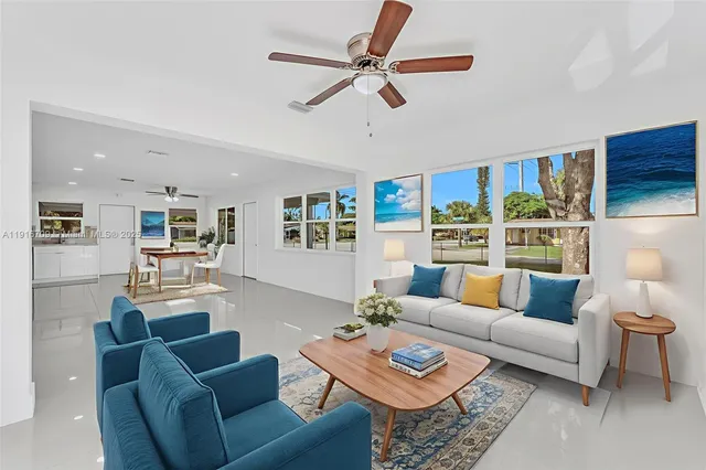 a living room with furniture a rug and a window