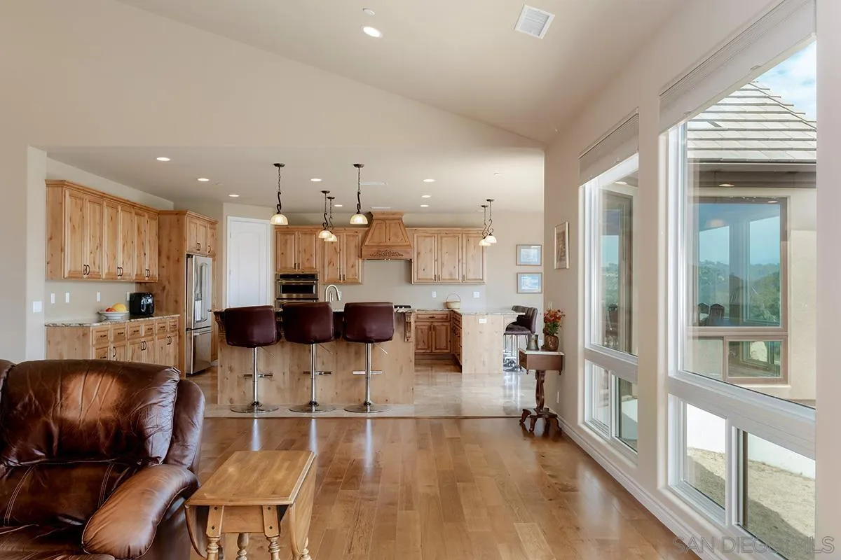 19840 7th Place Escondido, CA 92029 - Photo 14 of 49 a view of a dining room with furniture a kitchen and chandelier