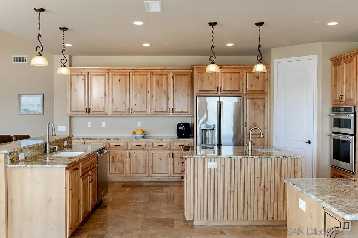 19840 7th Place Escondido, CA 92029 - Photo 18 of 49 a kitchen with stainless steel appliances granite countertop a refrigerator a stove and a sink